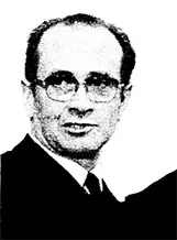 lack-and-white portrait of a Pierre Desnos wearing a formal suit and tie against a plain background